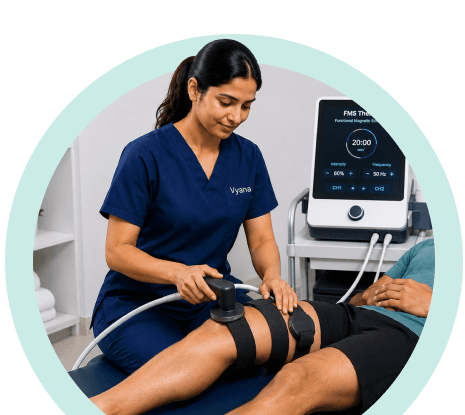 Vyana physiotherapist treating a patient's leg with an FMS therapy machine in Ahmedabad