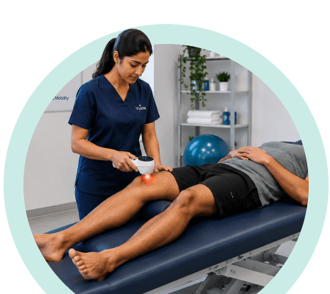 Vyana physiotherapist treating a patient's knee with a laser therapy device in Ahmedabad