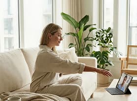 Woman relaxing at home following a personalised physiotherapy recovery programme