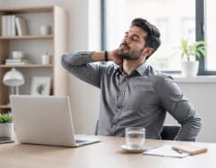 Working professional taking a moment to stretch from desk work