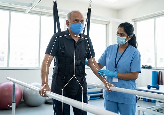 Physiotherapist supporting a patient during neurological rehabilitation exercise