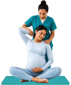 Trainer guiding a pregnant woman through a calm prenatal yoga session