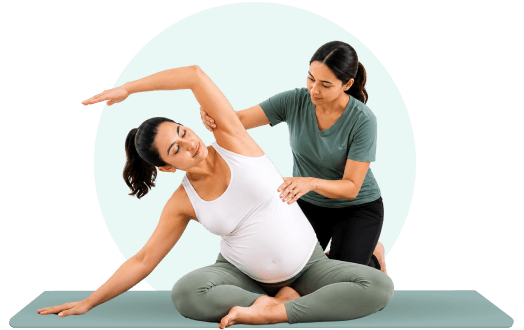 Pregnant woman supported by trainer in a gentle prenatal yoga pose